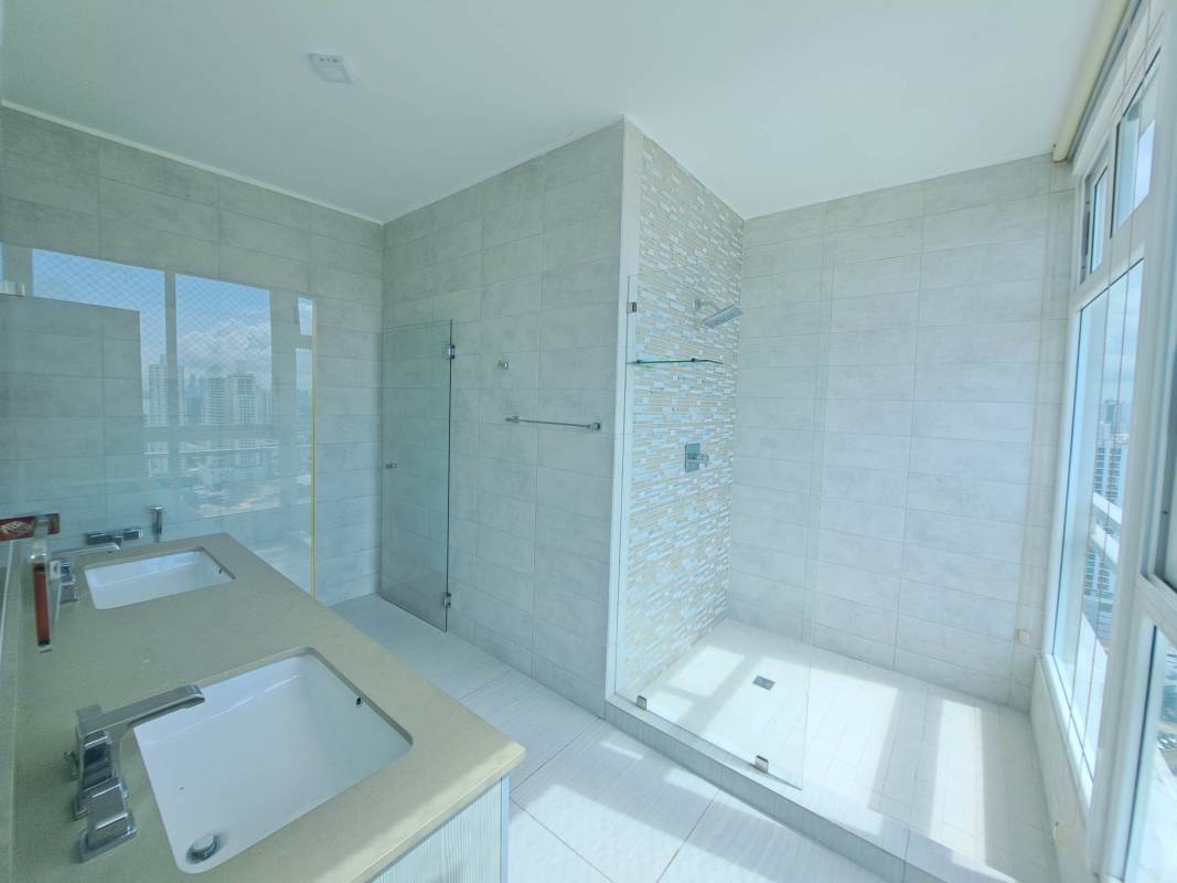 Spacious bedroom with walk-in closet and large window city view in The Towers Residences Panama