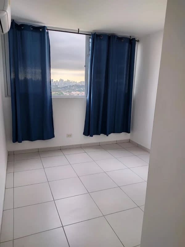 Minimalist bedroom with tile floors, white walls, built-in closet in El Crisol Towers apartment