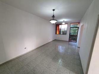 Living room with white walls, ceramic tile floor, balcony door PH Vistas del Atlántico Colón Panama