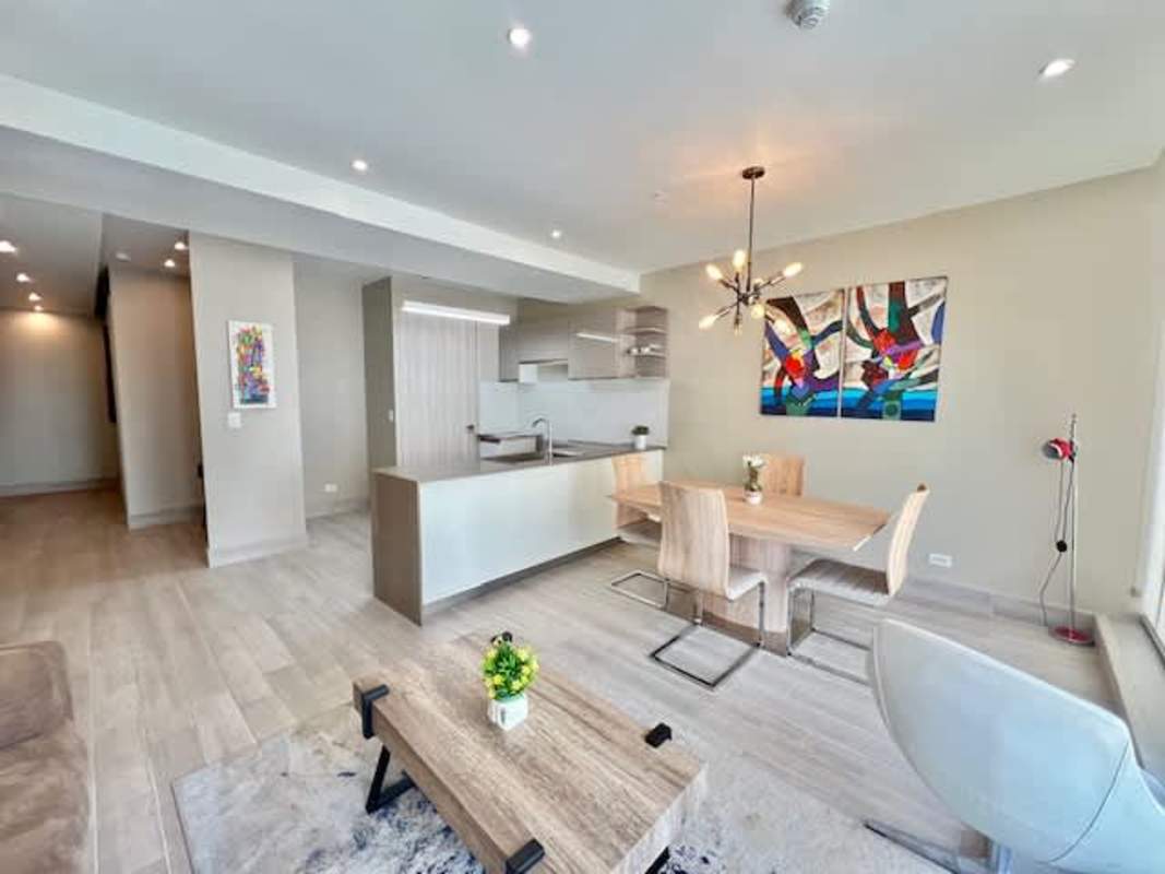 Fully equipped gym with large windows showing Panama City skyline at PH Bella Vista Tower