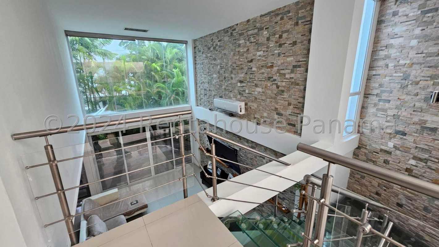 Contemporary kitchen with granite island stainless appliances dark cabinets in Costa Sur house Panama