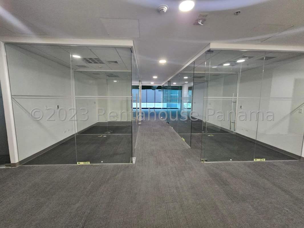 Office hallway with glass walls and carpeting Costa del Este tower