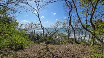 Aerial shot of secluded Pacific beach with rocks lush greenery Cambutal Panama