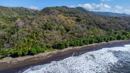 View of dense tropical vegetation near ocean with partially clear sky Cambutal Panama