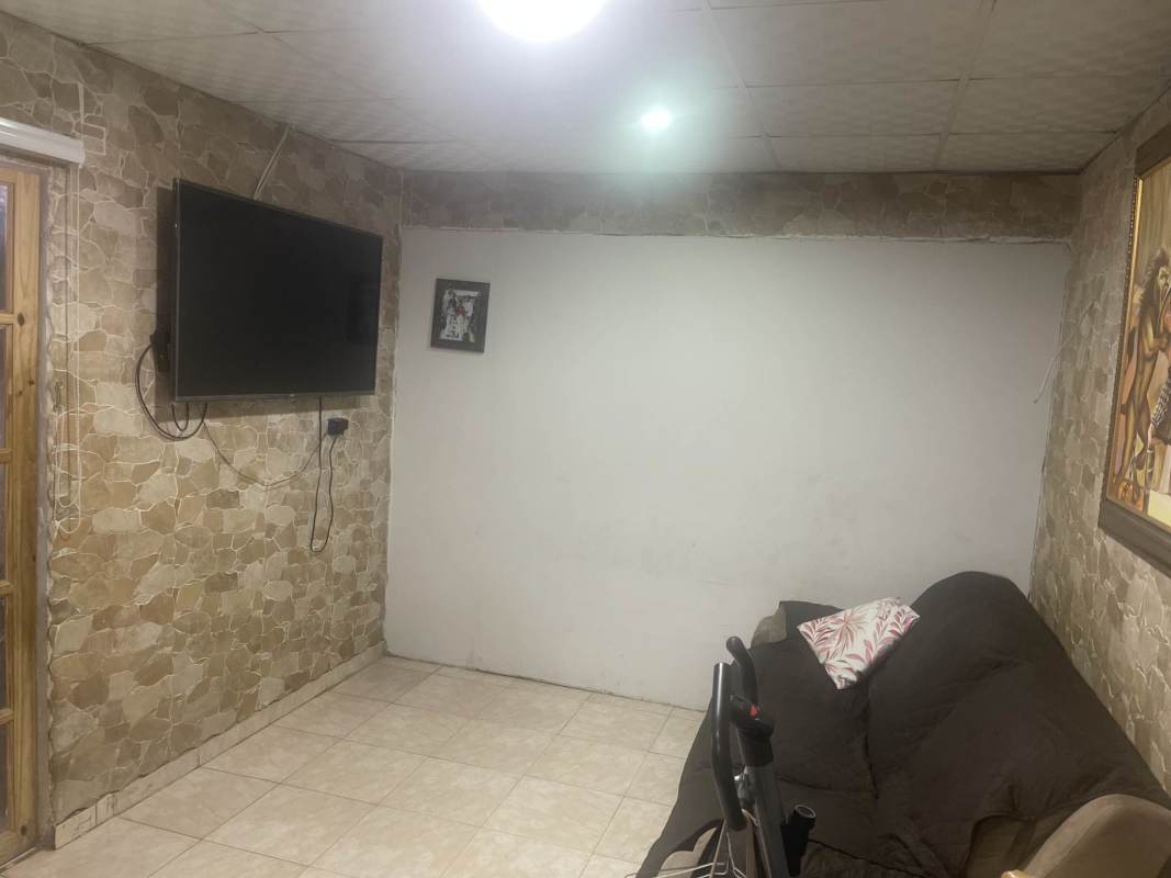 Rustic living room with stone pattern wall and mounted TV Parque Santa Lucía Panama