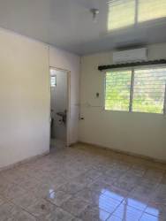 Unfurnished bedroom with tiled floor, AC unit, attached bathroom in La Enea Guararé Los Santos Panama