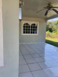 Covered backyard patio with ceiling fan, tiled floor La Enea Guararé Panama