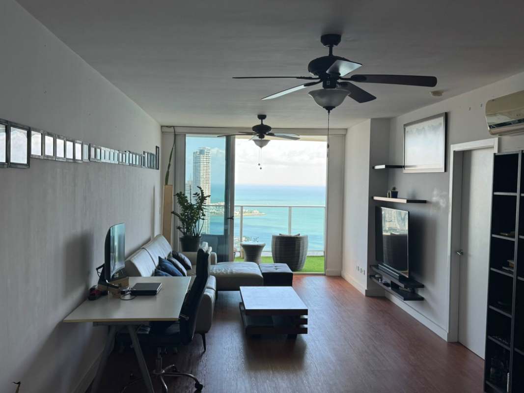 Modern furnished bedroom with large windows overlooking ocean at PH BICSA Panama City