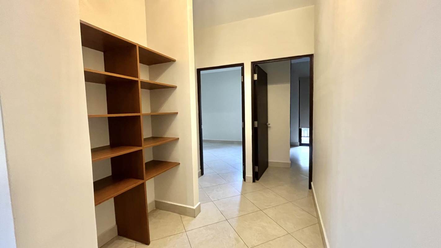 Hall with built-in wooden shelves, porcelain floor, bright walls in PH Embassy Club Clayton Panama