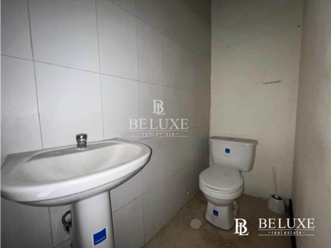 Minimalist tiled bathroom with sink and toilet in commercial space El Cangrejo Panama