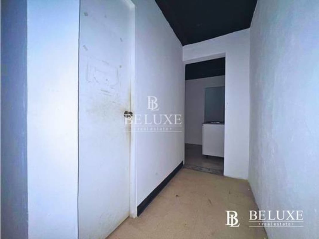 Simple interior hallway entrance to commercial space with painted ceiling in Panama