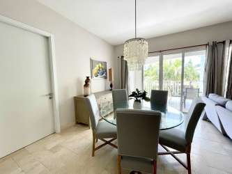 Modern fitted kitchen with island and elegant dining space inside PH Puntarena Buenaventura Panama