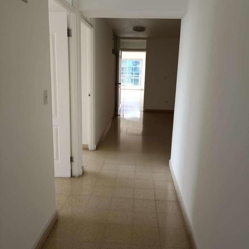Bright internal corridor with doors leading to rooms Calle 50 apartment
