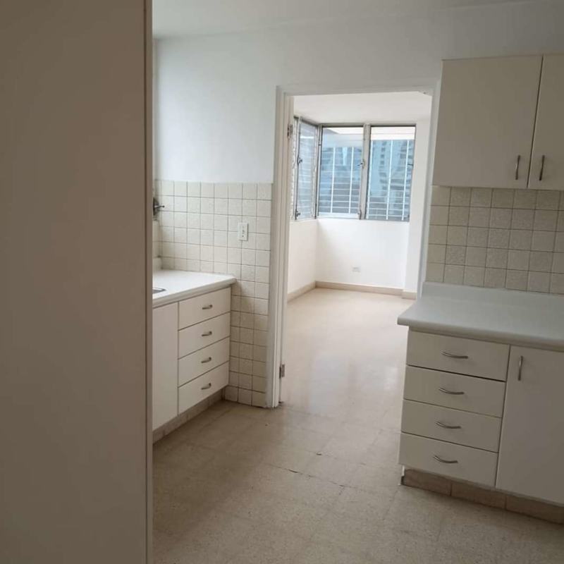 Bright enclosed laundry or balcony with windows in Calle 50 apartment Panama