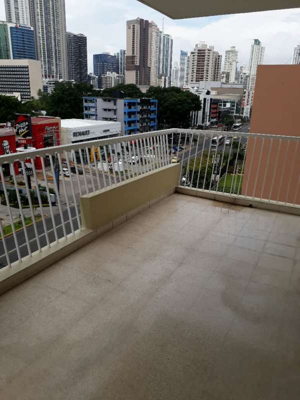 Large covered balcony with city skyline views Calle 50 apartment Panama