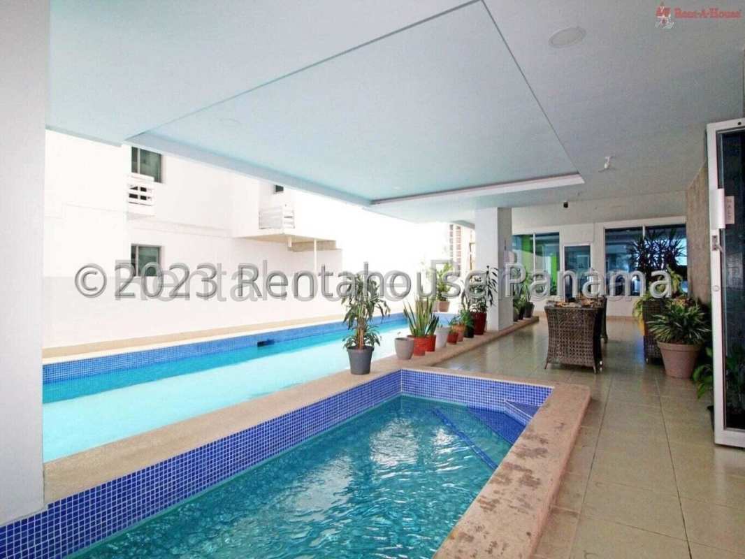 Bright lobby with teal walls, black leather sofas, mirrors in PH San Francisco Bay Panama