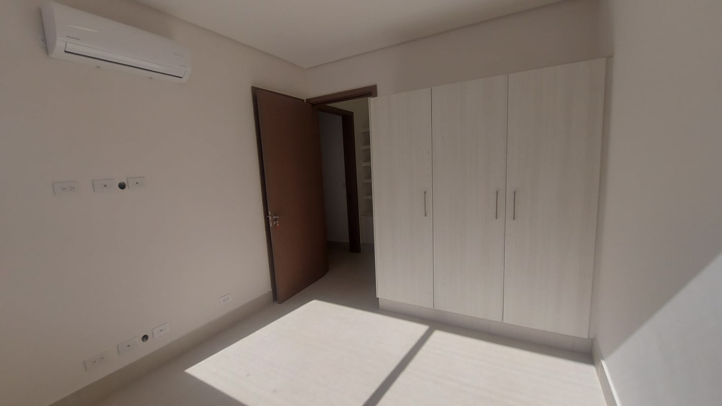 Modern open kitchen with granite counters and breakfast island in RiverWalk Green City Panama