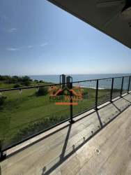 Pool area with sun loungers and ocean backdrop at PH Solaria San Carlos Panama