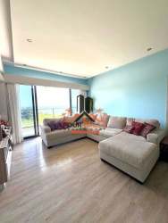 Open-plan living and dining room inside PH Solaria apartment with large windows and ceramic floors