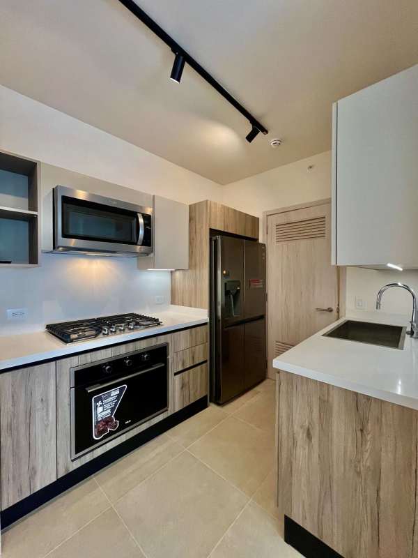 Stylish kitchen with quartz countertop, stainless appliances PH Ocean House