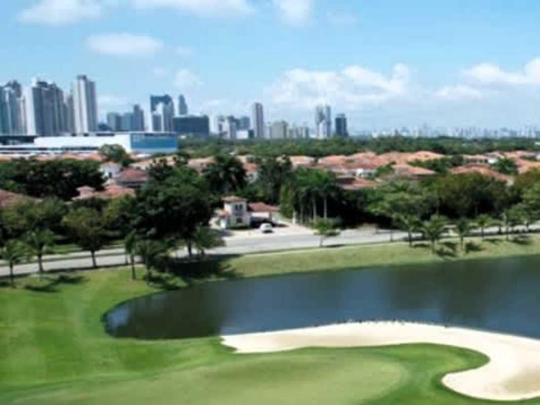 Golf course with pond and skyline backdrop The Reserve Panama City