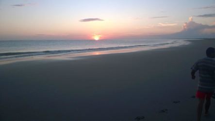 Beautiful sunset view with calm waves on sandy shore Isla Caña Panama