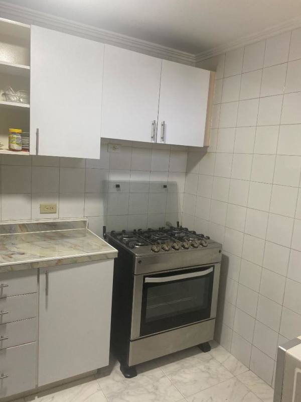 Contemporary dining room with glass table upholstered chairs tile floors PH Edison Park Panama