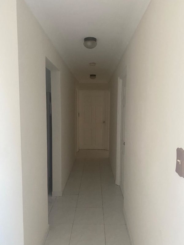 Living dining room with dining table, TV, tile floors in PH Edison Park Panama female apartment rental