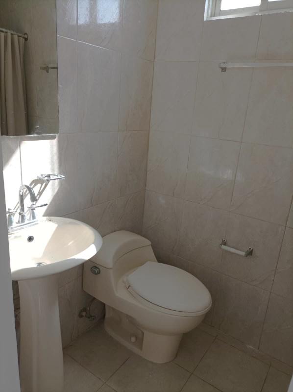 Minimal bathroom with pedestal sink and ceramic tiles PH Plaza Marquez Panama City