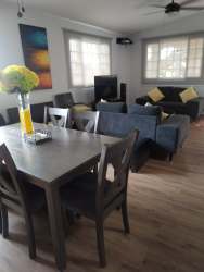 Spacious covered rear terrace with dining set and garden view at Villa de Ensueños house Las Lajas Panama