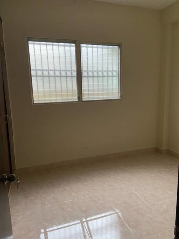 Spacious empty interior room with large window and tile floors in Panama apartment rental