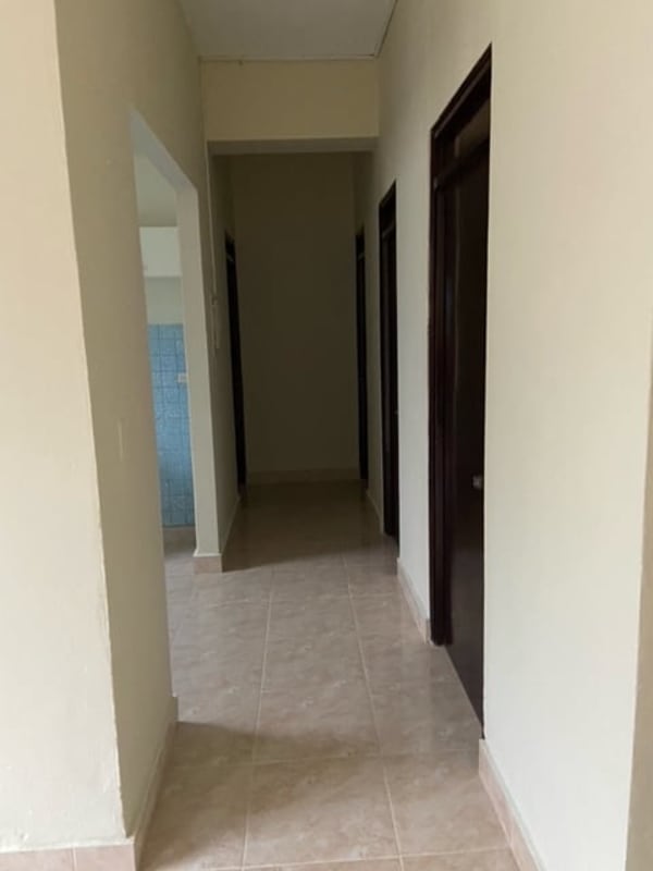 Bedroom interior with dark wooden built-in wardrobes in Panama apartment rental