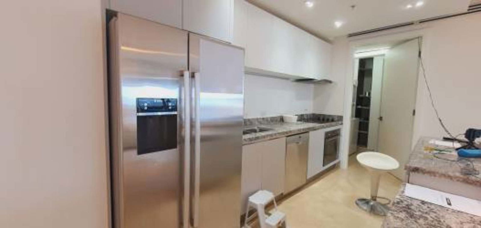 Kitchen with stainless appliances, granite countertops, and white cabinetry in Punta Pacifica condo