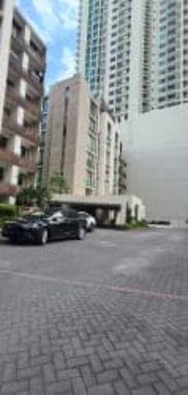 Facade of Oceanaire high-rise with multiple floors, entrance driveway, and landscaped gardens Punta Pacífica