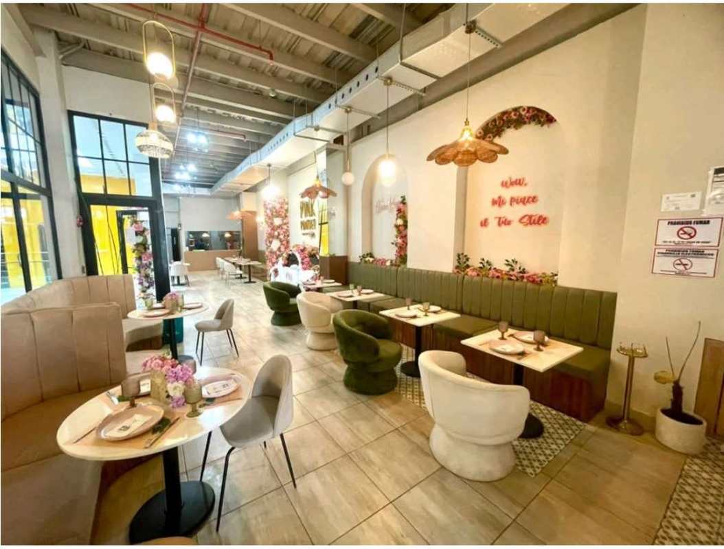 Modern stylish restaurant with floral installations booth seating marble tables in Casco Viejo Panama