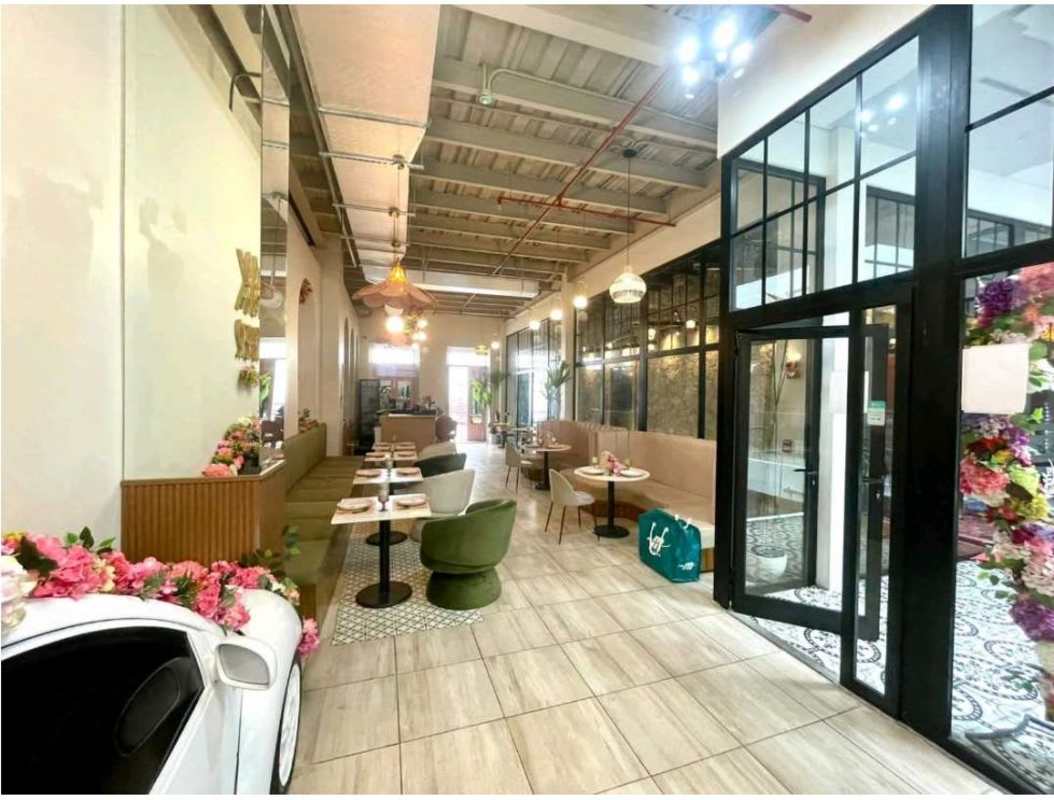 Stylish modern restaurant with floral decor, booth seating, exposed ceiling near Plaza Catedral Casco Viejo Panama