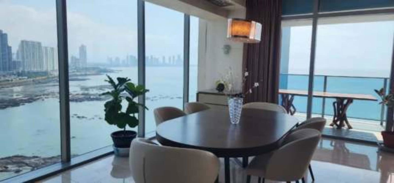 Contemporary living space with marble floors and ocean view at Grand Tower Punta Pacifica Panama