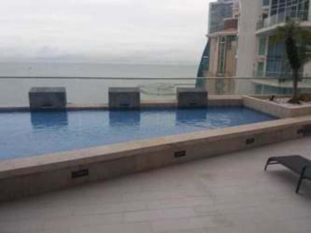 Spacious indoor pool with gym equipment and lounge area at Loft 41 Punta Pacifica Panama