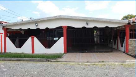 Front entrance of house with red wall white door barred window lamp