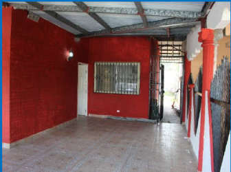 Covered parking with wrought iron gate and tiled drive at Vista Alegre house