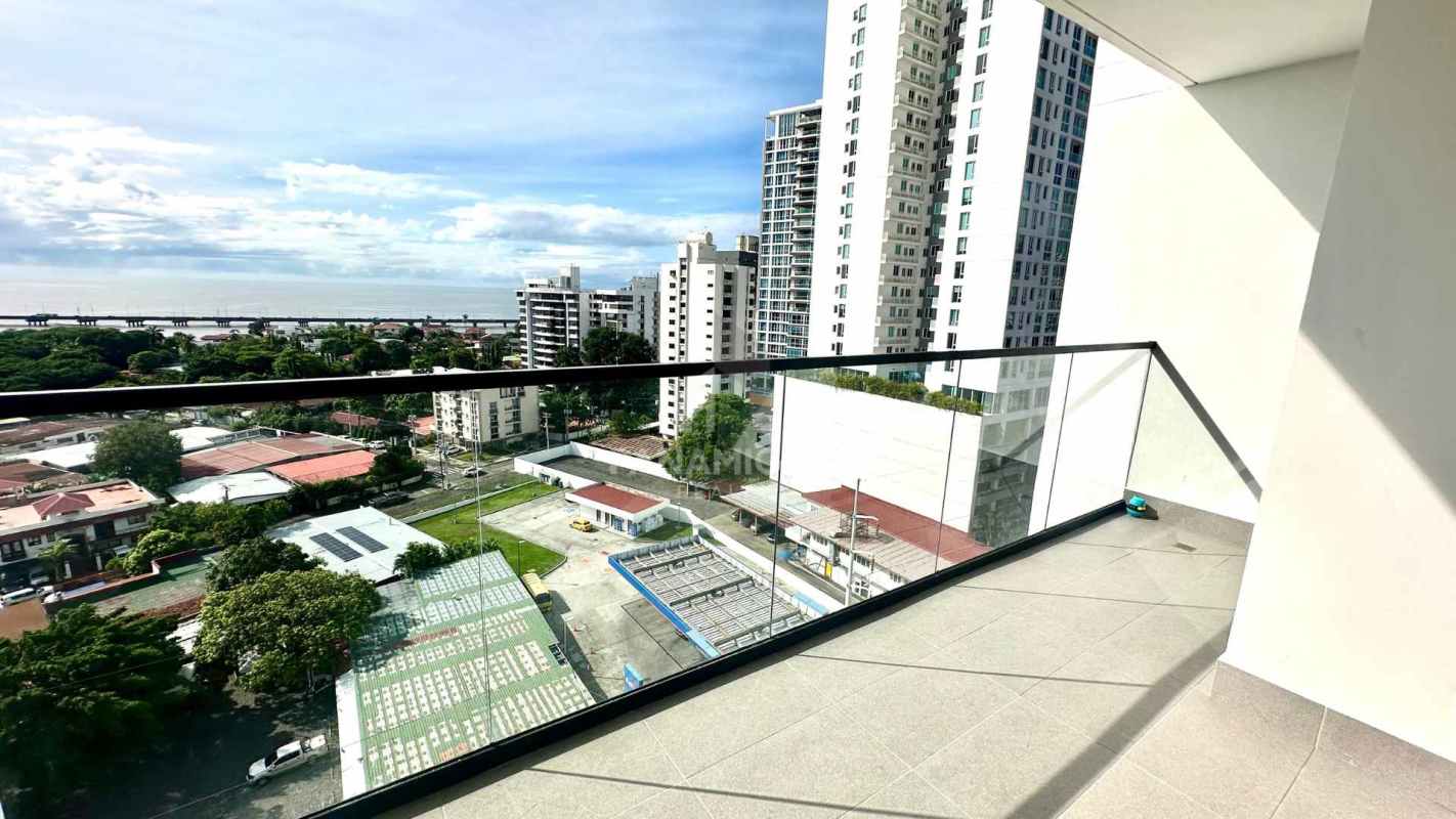 Modern high-rise balcony glass railing panoramic views of ocean and Panama City skyline at Victory Wellness Coco del Mar