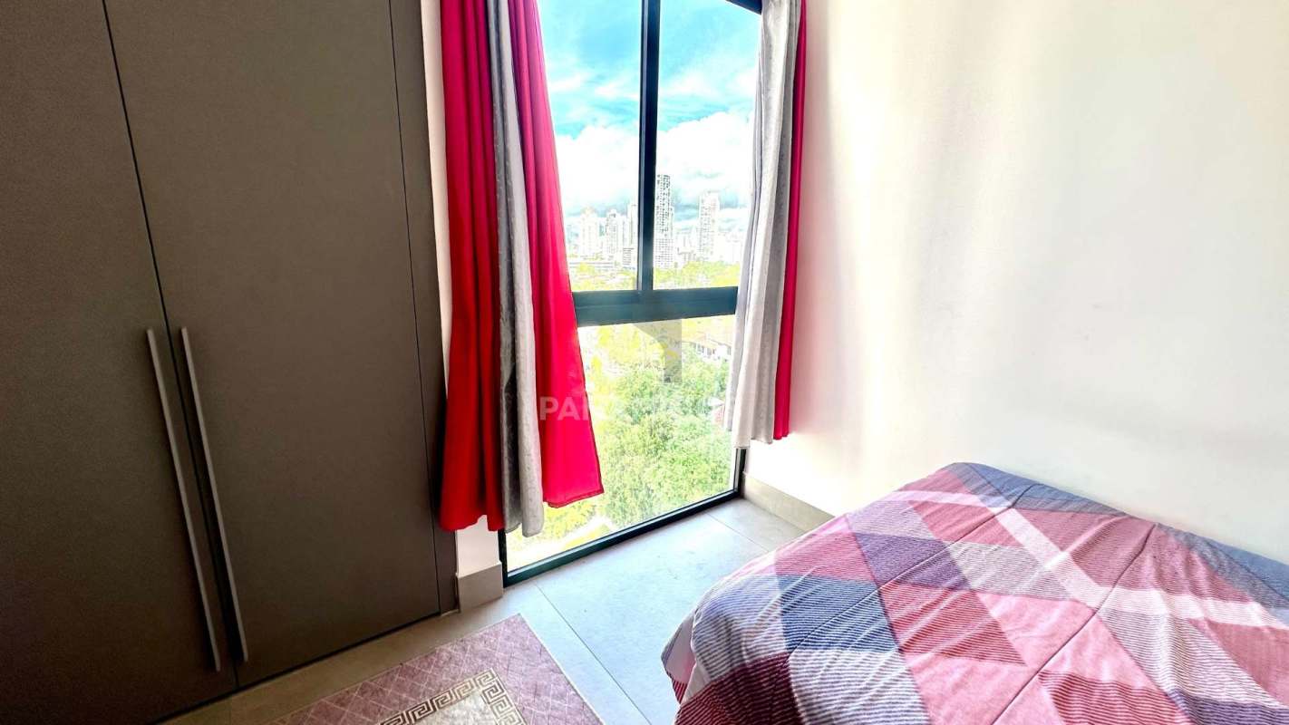 Modern bedroom with floor-to-ceiling windows, built-in wardrobe and city skyline view at Victory Wellness Coco del Mar