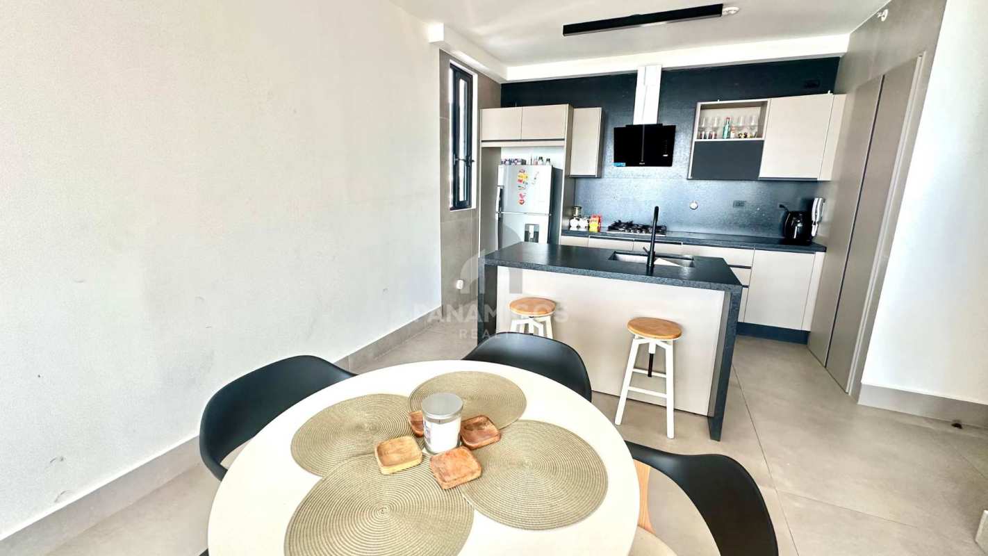 Contemporary kitchen with island seating, modern lighting and finishes at PH Victory Wellness Coco del Mar Panama City