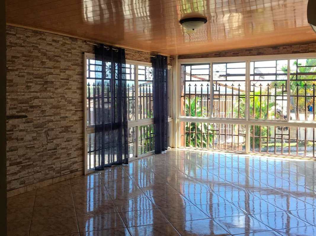 Bright room with stone accent wall, large windows in Villa Zaita rental Panama