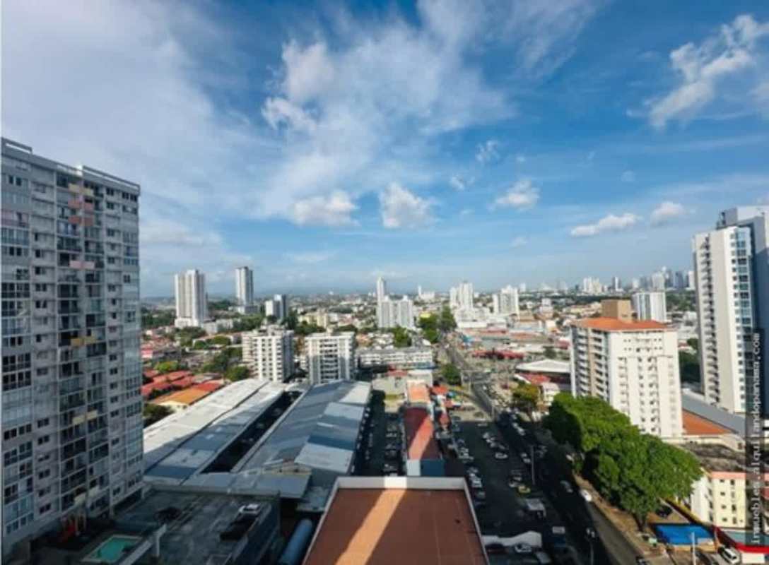 Panama City skyline with PH Gaudi tower and surrounding neighborhoods under blue sky