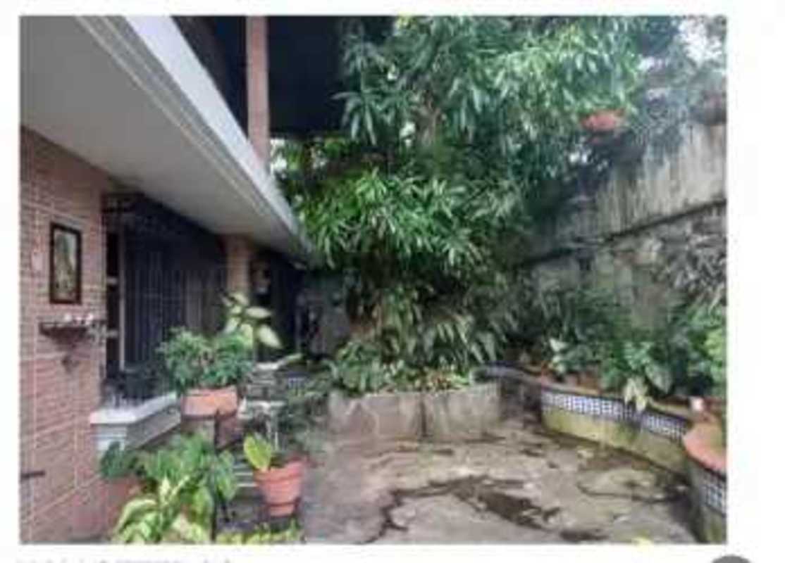 Outdoor patio with garden, greenery, and brick wall in Obarrio Panama real estate