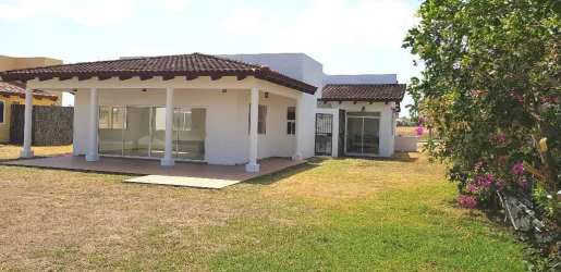 Spacious living room with natural light and open kitchen for sale in Nueva Gorgona beach house Panama