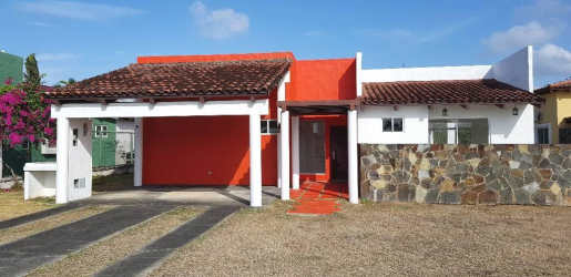 Covered terrace opens into spacious backyard garden at Nueva Gorgona Panama beach house for sale