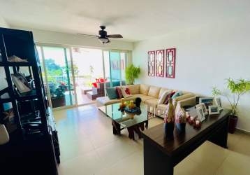 Contemporary kitchen with granite counters, breakfast bar, and stone accent wall in Bijao Balboa Tower