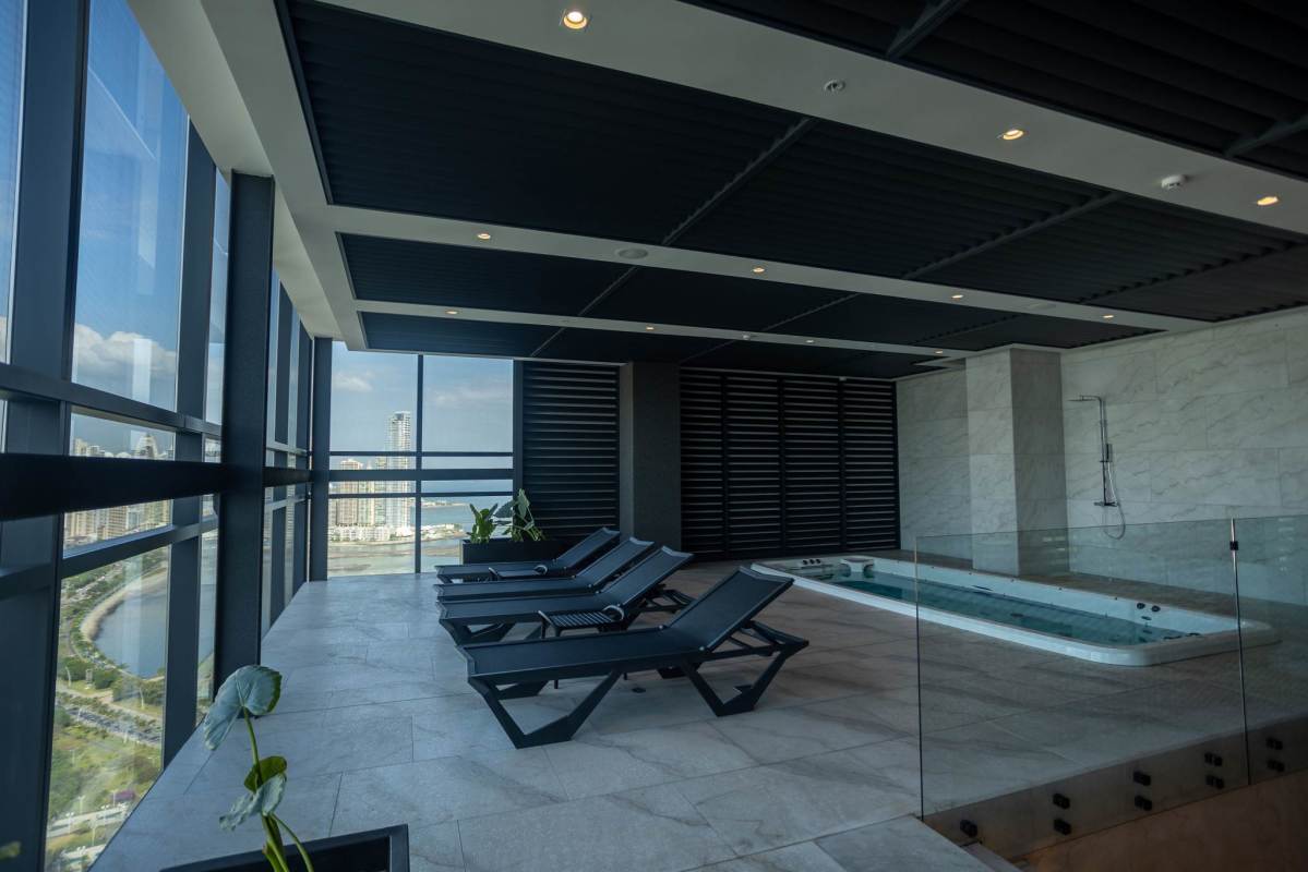 Modern equipped gym with panoramic city skyline views at Nuovo by Armani Panama